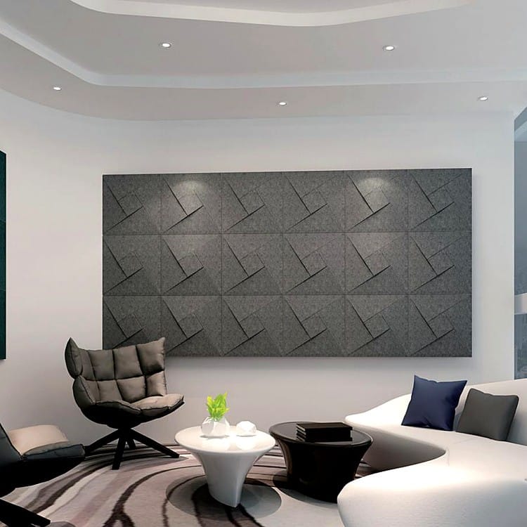 Dark charcoal Spin Square felt tiles creating a dynamic geometric pinwheel wall installation in a contemporary room.