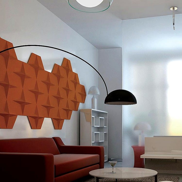Stellar Glow felt panels in a deep orange hue feature dimensional star facets mounted above a modern red lounge sofa.