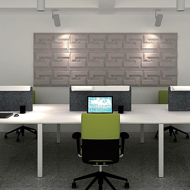 Town Tales grey acoustic wall tiles with recessed maze-like patterns mounted above a modern desk arrangement.