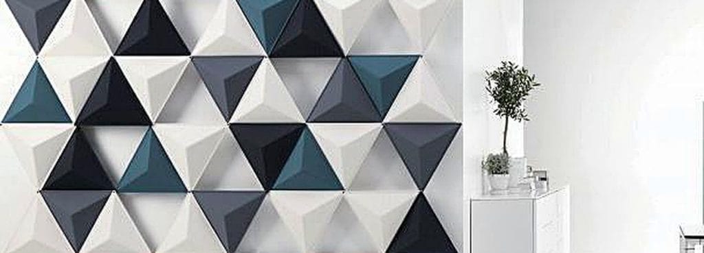 Tri Prism acoustic wall panels feature faceted triangular felt shapes in shades of blue, grey, and white.