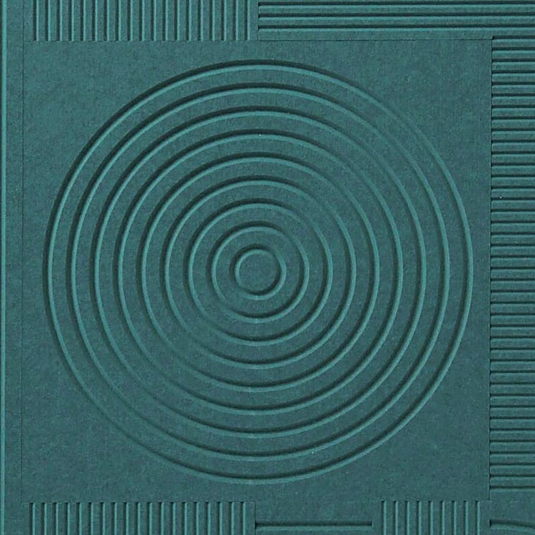 Close-up of a V-Flute Carved Acoustic Panel in matte green PET felt showcasing recessed circular and linear grooves.