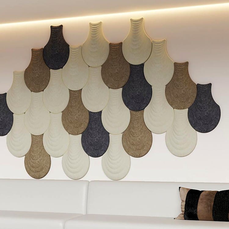 Interlocking Vase Form acoustic panels in a mix of cream, tan, and charcoal PET felt mounted on a modern white wall.