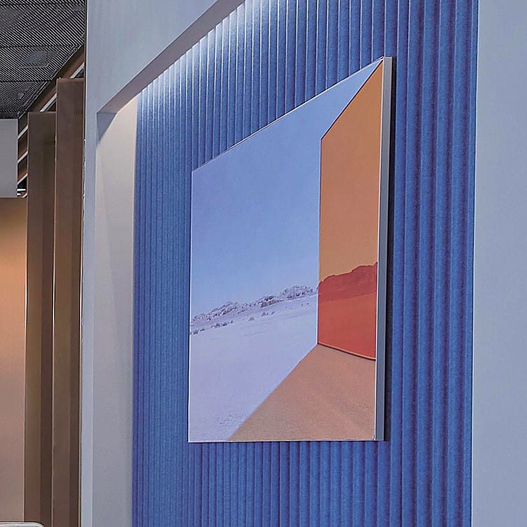 Blue Wave-Patterned Acoustic Panel wall covering with a modern desert landscape art piece mounted on top.